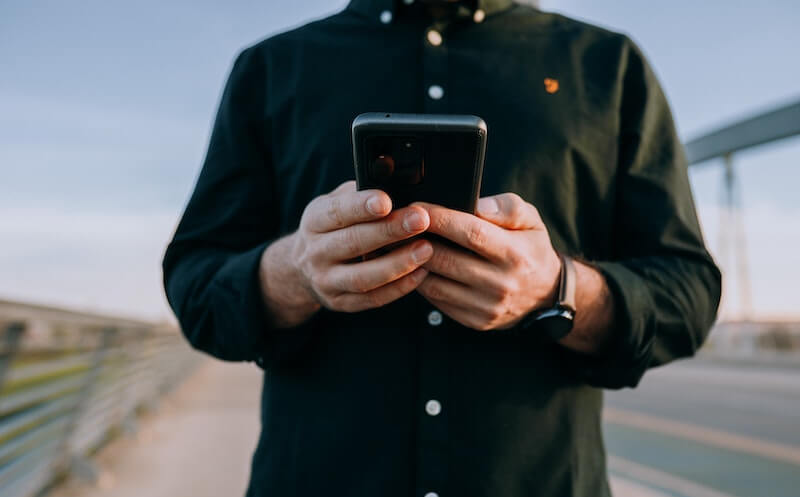 man holding his phone rental device